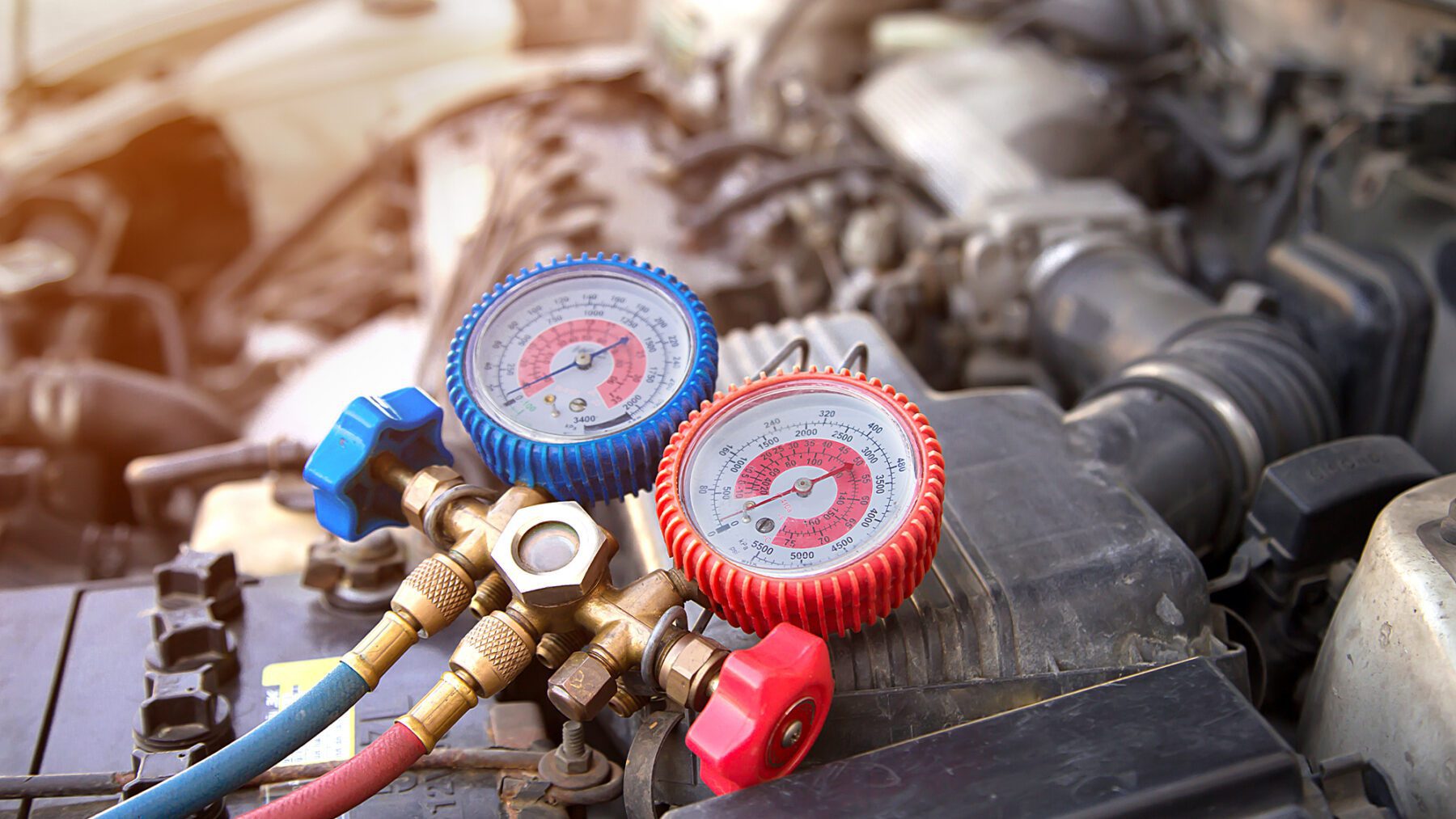 Mechanic performing a cooling system check on a car in spring