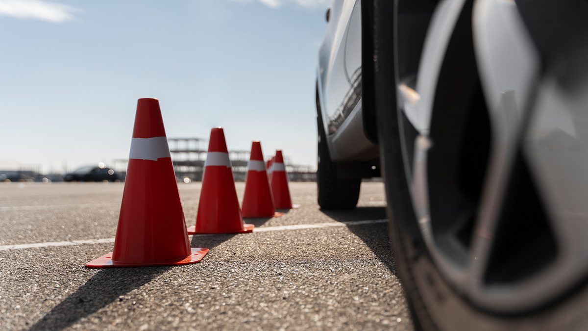 A car navigating wet roads during spring, highlighting common spring driving hazards